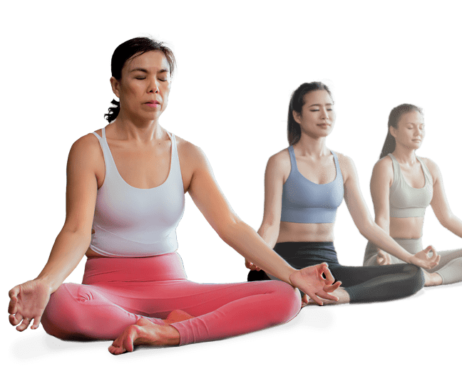 Three meditating women sitting cross-legged with eyes closed, hands in mudras on their knees.