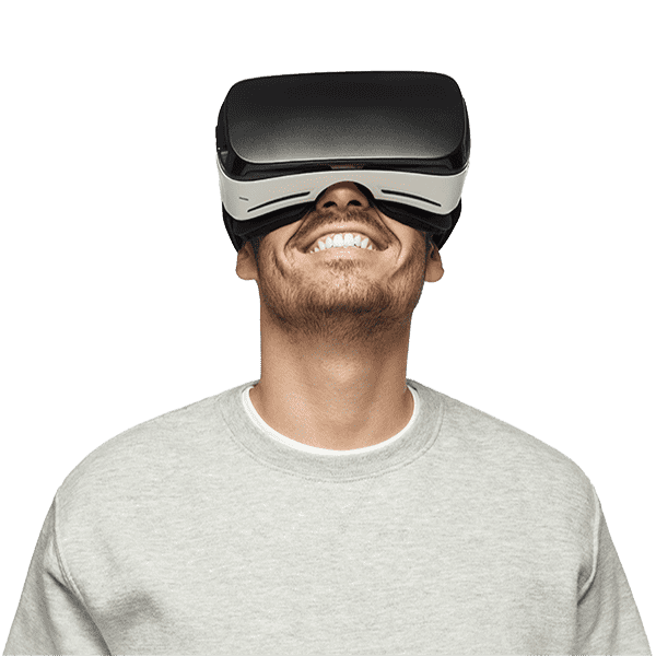 Smiling young man wearing a VR headset looking upwards.