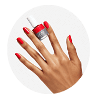 Hand with freshly painted nails and bottle of peach Cote nail polish between the pointer and middle fingers.