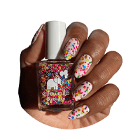 Hand with freshly painted nails holding bottle of birthday sprinkles Ella and Mila nail polish.