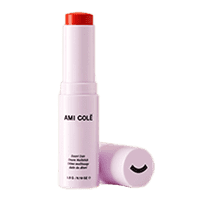 Open container of Ami Cole Desert Date Cream Multistick in red Flame color next to its lid.